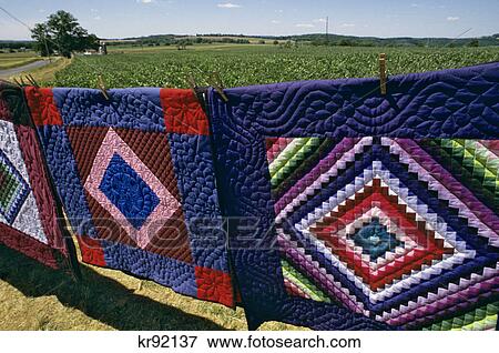 1990s PENNSYLVANIA DUTCH AMISH PATCHWORK QUILTS FOR SALE ALONGSIDE A CORN FIELD LANCASTER COUNTY PENNSYLVANIA USA View Large Photo Image Stock Photo - 1990s PENNSYLVANIA DUTCH AMISH PATCHWORK QUILTS FOR SALE ALONGSIDE A CORN FIELD LANCASTER COUNTY PENNSYLVANIA USA. Fotosearch