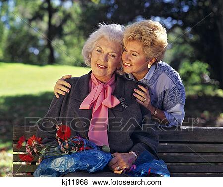 1990s SENIOR MOTHER AND ADULT DAUGHTER OUTDOORS View Large Photo Image Stock Photo - 1990s SENIOR MOTHER AND ADULT DAUGHTER OUTDOORS. Fotosearch