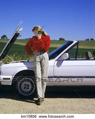 1990s WOMAN WITH CAR TROUBLE ON CELLULAR PHONE CALLING FOR ROADSIDE ASSISTANCE View Large Photo Image Stock Photograph - 1990s WOMAN WITH CAR TROUBLE ON CELLULAR PHONE CALLING FOR ROADSIDE ASSISTANCE. Fotosearch