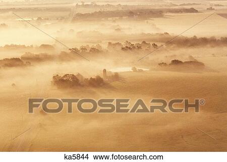 Picture - AERIAL VIEW OF FARM IN EARLY MORNING FOG NEAR EDGERTON KANSAS USA. Fotosearch