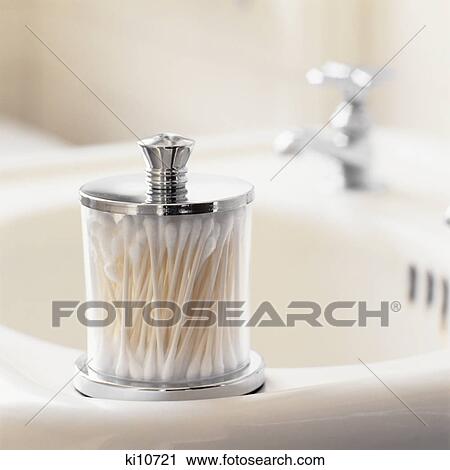 ANTIQUE GLASS CONTAINER OF COTTON SWABS ON 1930s 1940s WHITE PORCELAIN SINK View Large Photo Image Stock Image - ANTIQUE GLASS CONTAINER OF COTTON SWABS ON 1930s 1940s WHITE PORCELAIN SINK. Fotosearch