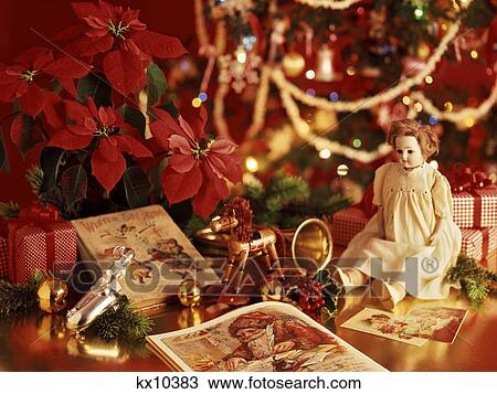 Stock Image - Antique Toys Poinsettia Under Christmas Tree. Fotosearch
