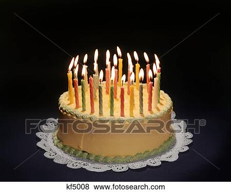 Stock Photo - BIRTHDAY CAKE WITH MANY BURNING CANDLES. Fotosearch