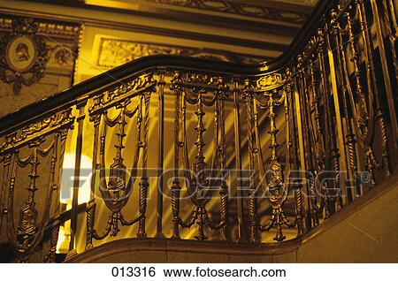 Stock Photograph - CAST IRON STAIRWELL WOODEN BANNISTER AND METAL BALUSTERS. Fotosearch