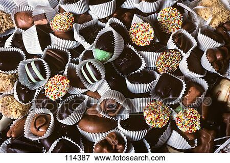 Chocolate Candies In White Paper Cups All In A Pile Some With Sprinkles View Large Photo Image Stock Photo - Chocolate Candies In White Paper Cups All In A Pile Some With Sprinkles. Fotosearch