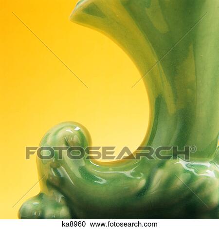 CLOSE-UP DETAIL OF GREEN POTTERY VASE AGAINST YELLOW BACKGROUND View Large Photo Image Stock Image - CLOSE-UP DETAIL OF GREEN POTTERY VASE AGAINST YELLOW BACKGROUND. Fotosearch