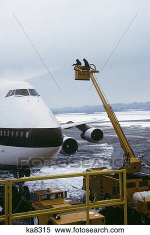 Stock Photography - Deicing Plane Prior To Flight. Fotosearch
