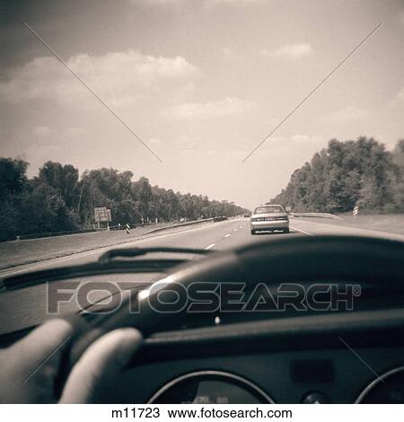 Driver View Of Highway Over Automobile Dashboard Hand On Steering Wheel View Large Photo Image Stock Image - Driver View Of Highway Over Automobile Dashboard Hand On Steering Wheel. Fotosearch