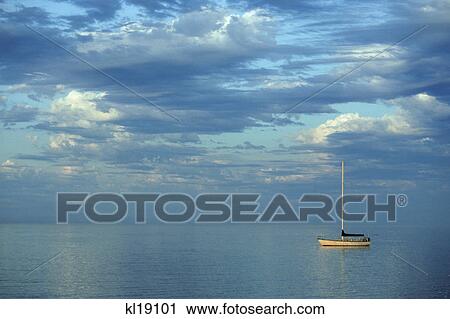 Stock Image - LONE SAILING BOAT MOORED IN HARBOR PORT ANGELES WASHINGTON. Fotosearch