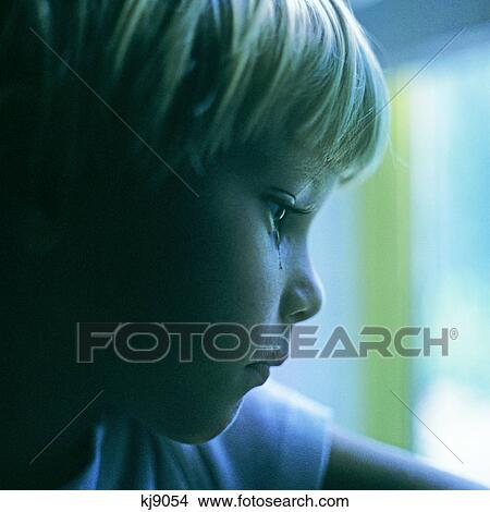 SAD BLOND BOY WITH A TEAR IN HIS EYE LOOKING OUT WINDOW View Large Photo Image Picture - SAD BLOND BOY WITH A TEAR IN HIS EYE LOOKING OUT WINDOW. Fotosearch