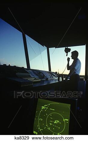 Silhouetted Air Traffic Controller In Control Tower On Hand Held Radio View Large Photo Image Stock Photo - Silhouetted Air Traffic Controller In Control Tower On Hand Held Radio. Fotosearch