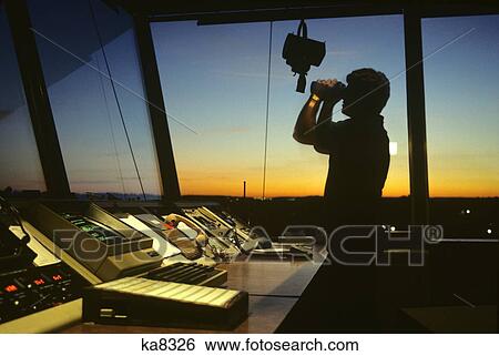 Silhouetted Air Traffic Controller In Control Tower Using Binoculars View Large Photo Image Stock Photograph - Silhouetted Air Traffic Controller In Control Tower Using Binoculars. Fotosearch