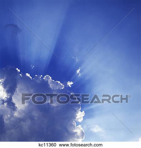 SUN'S RAYS AROUND CUMULUS CLOUDS View Large Photo Image Stock Image - SUN'S RAYS AROUND CUMULUS CLOUDS. Fotosearch