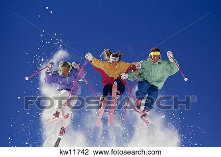 Three Airborne Skiers In Multicolored Clothing With Snow Flying Vail Colorado Usa View Large Photo Image Stock Image - Three Airborne Skiers In Multicolored Clothing With Snow Flying Vail Colorado Usa. Fotosearch