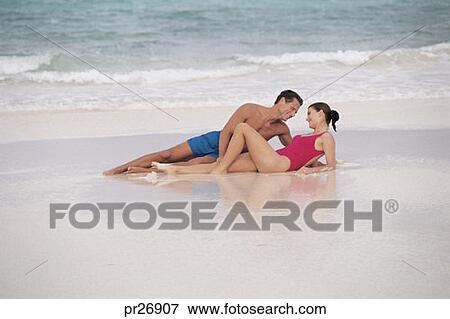 Couple Laying On Beach Stock Photo Pr26907 Fotosearch