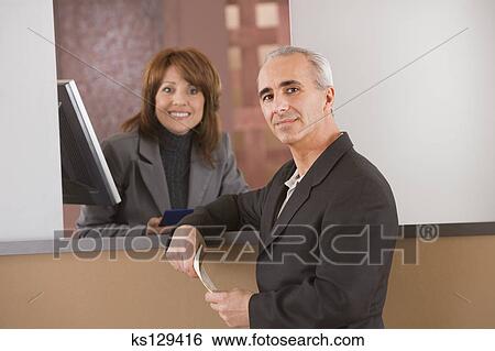Man And Bank Teller Stock Photograph Ks129416 Fotosearch