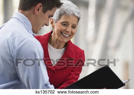 Stock Photo - Businesswoman with intern. Fotosearch - Search Stock Photography, Print Pictures, Images, and Photo Clip Art