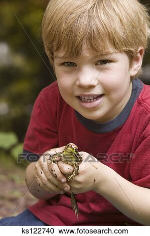 Stock Photography of Little boy holding a frog, portrait. ks122740 ...