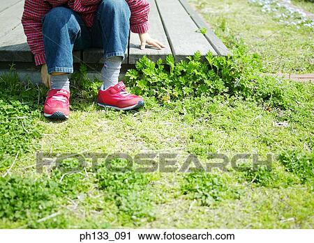 A young child putting on shoes View Large Photo Image Stock Image - A young child putting on shoes. Fotosearch