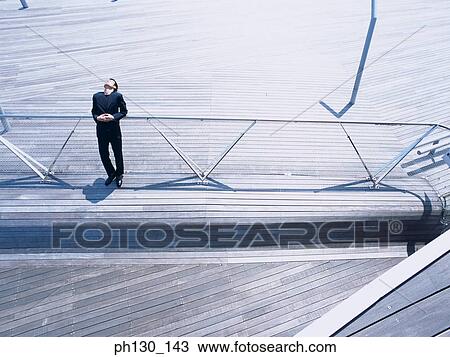 Aerial view of a man leaning over a railing View Large Photo Image Stock Image - Aerial view of a man leaning over a railing. Fotosearch