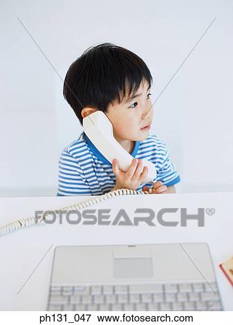 Stock Photo - Asian child on the phone. Fotosearch