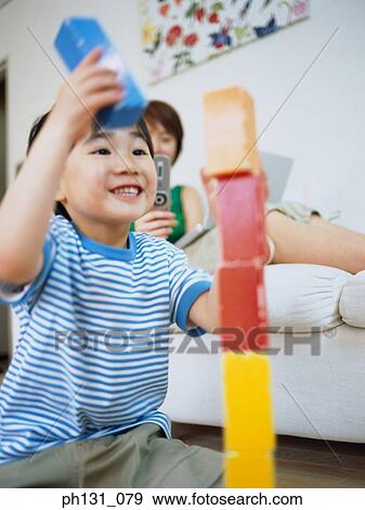 Stock Photo - Asian child playing with blocks. Fotosearch