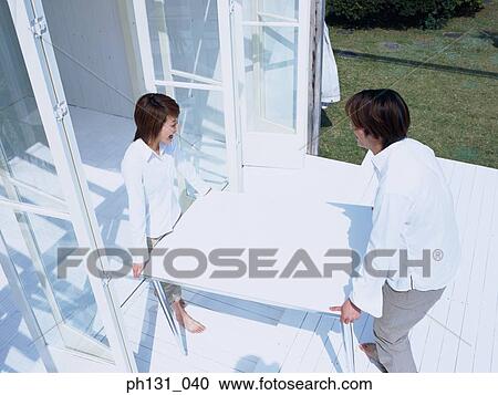 Asian couple carrying a table to the porch View Large Photo Image Stock Image - Asian couple carrying a table to the porch. Fotosearch