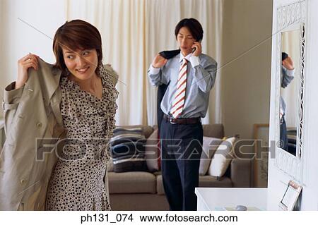 Asian couple getting ready to leave View Large Photo Image Picture - Asian couple getting ready to leave. Fotosearch