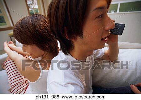 Asian couple sitting together View Large Photo Image Stock Photography - Asian couple sitting together. Fotosearch