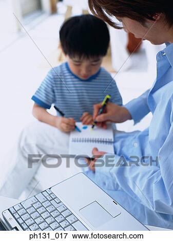 Asian father and son coloring in a notebook View Large Photo Image Stock Photo - Asian father and son coloring in a notebook. Fotosearch