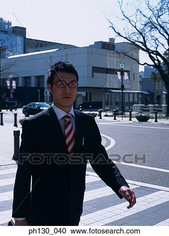Asian Man crossing the street View Large Photo Image Stock Image - Asian Man crossing the street. Fotosearch