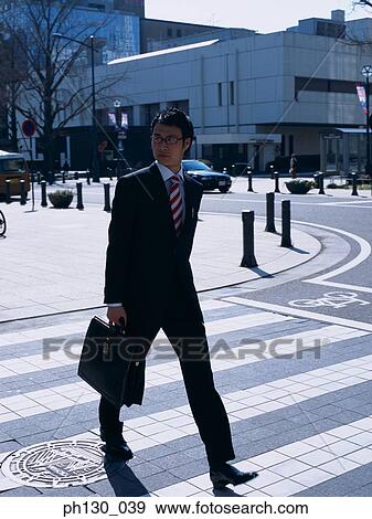 Asian Man crossing the street View Large Photo Image Stock Photo - Asian Man crossing the street. Fotosearch