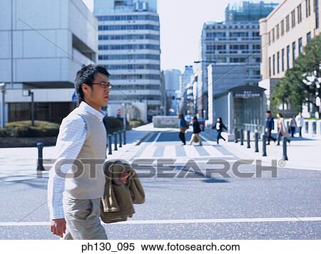Asian Man crossing the street View Large Photo Image Stock Photography - Asian Man crossing the street. Fotosearch