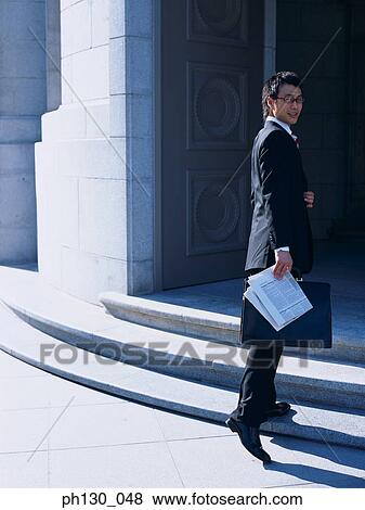 Stock Photo - Asian Man entering his office. Fotosearch