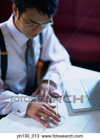 Asian Man holding the stem of a wine glass View Large Photo Image Stock Image - Asian Man holding the stem of a wine glass. Fotosearch