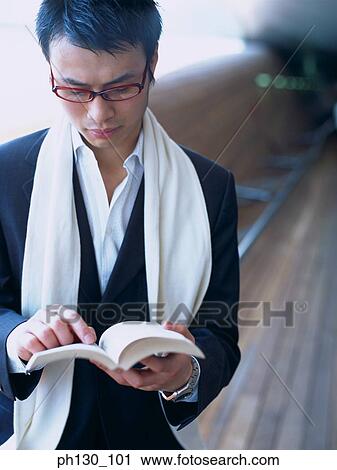 Asian Man reading on a bench View Large Photo Image Stock Image - Asian Man reading on a bench. Fotosearch