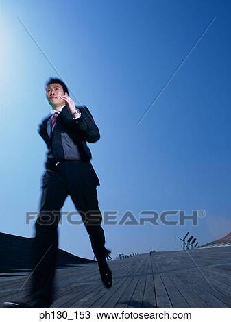 Asian Man running down a bridge View Large Photo Image Stock Image - Asian Man running down a bridge. Fotosearch