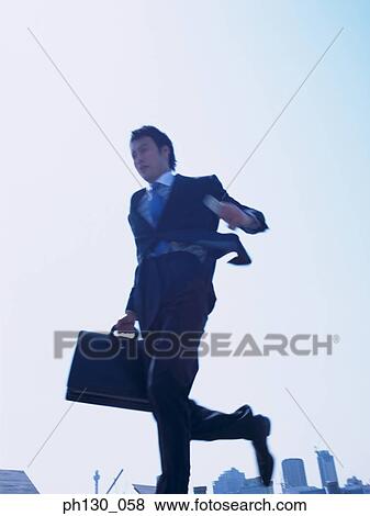 Asian Man running on a walkway View Large Photo Image Stock Photo - Asian Man running on a walkway. Fotosearch