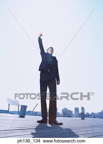 Asian Man shouting from a bridge View Large Photo Image Picture - Asian Man shouting from a bridge. Fotosearch