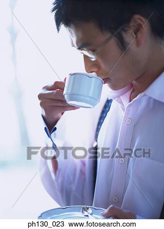Asian Man sipping tea View Large Photo Image Stock Image - Asian Man sipping tea . Fotosearch
