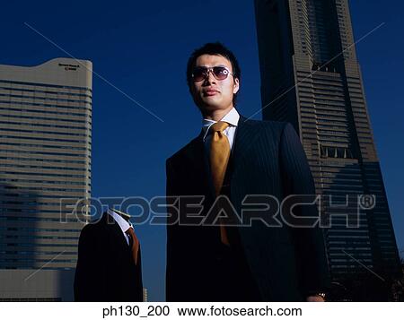 Asian Man standing in a lot with a mannequin View Large Photo Image Stock Image - Asian Man standing in a lot with a mannequin. Fotosearch