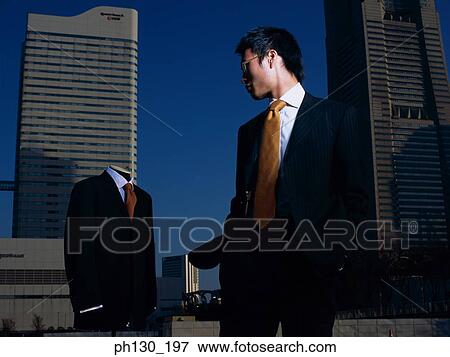 Asian Man standing in a lot with a mannequin View Large Photo Image Stock Photo - Asian Man standing in a lot with a mannequin. Fotosearch