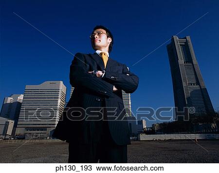 Asian Man standing in an empty parking lot View Large Photo Image Stock Image - Asian Man standing in an empty parking lot. Fotosearch