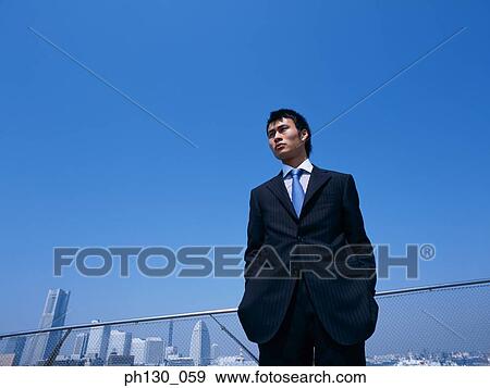 Asian man standing View Large Photo Image Stock Photo - Asian man standing. Fotosearch
