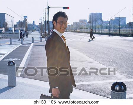 Asian Man waiting at a curb View Large Photo Image Stock Photography - Asian Man waiting at a curb. Fotosearch