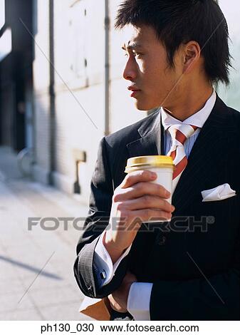 Asian Man waiting by the street View Large Photo Image Stock Image - Asian Man waiting by the street. Fotosearch