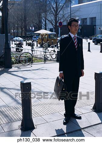 Asian Man waiting to cross the street View Large Photo Image Stock Photo - Asian Man waiting to cross the street. Fotosearch