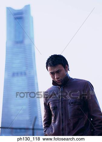 Stock Photo - Asian Man walking in the cold. Fotosearch