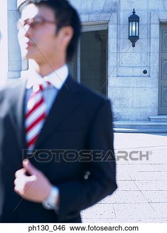 Asian Man walking on the sidewalk View Large Photo Image Stock Photograph - Asian Man walking on the sidewalk. Fotosearch