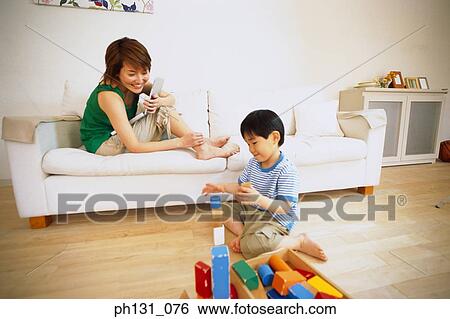 Stock Photograph - Asian mother and son playing with blocks. Fotosearch